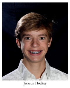 Jackson Hodkey as Vendor/Shop Clerk/ Mailman/Ensemble