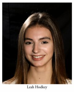 Leah Hodkey as Vendor/Shop Clerk/Mailman/Ensemble